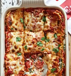 a casserole dish filled with lasagna and cheese