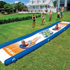 children playing in an inflatable pool on the lawn