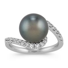 This delightfully charming fashion ring is crafted in quality 14 karat white gold and boasts one 9-10mm cultured Tahitian pearl in the center. Twenty-four round diamonds  at approximately .38 carat total weight  are pave-set and add a hint of sparkle. The ring measures 12.4mm at its widest and 2mm wide at the band. Hammered Silver Jewelry, Sterling Silver Name Necklace, Pearl And Diamond Ring, Natural Diamond Ring, Platinum Jewelry, Tahitian Pearls, Pearl Diamond, Sapphire Jewelry, Cultured Pearls