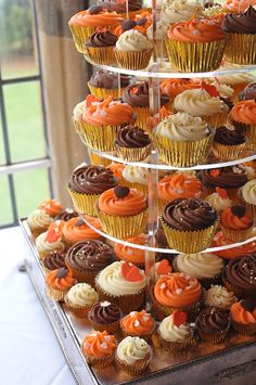 there are many cupcakes stacked up on the cake stand and ready to be eaten