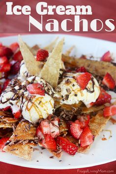 a white plate topped with ice cream and strawberries next to tortilla chips