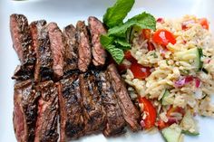 steak, rice and vegetables on a white plate