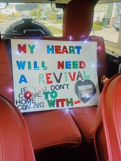 a sign in the back seat of a car that says, my heart will need a revival if you don't come to homes coming with it