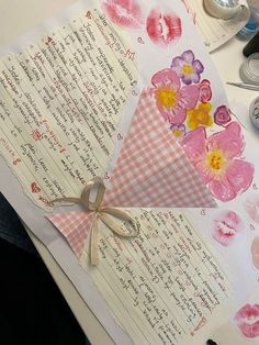 an open piece of paper with flowers on it and some crafting supplies around it