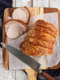 sliced pork on a cutting board with knife