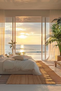 a bedroom with an ocean view at sunset