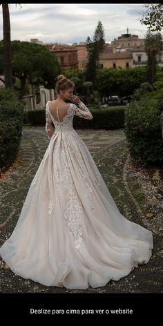 a woman in a wedding dress is posing for the camera