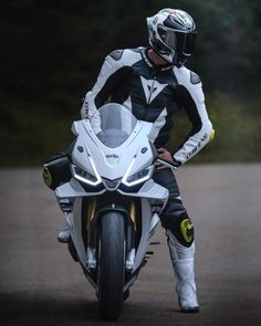 a man riding on the back of a white motorcycle