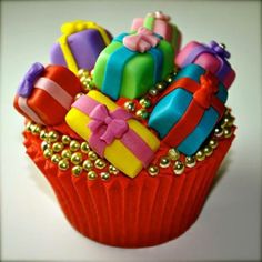 there is a cupcake decorated with colorful decorations