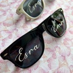 two pairs of sunglasses with the names esra and era written on one pair