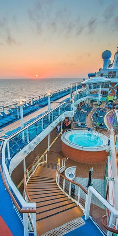 the deck of a cruise ship with a hot tub and stairs leading up to it