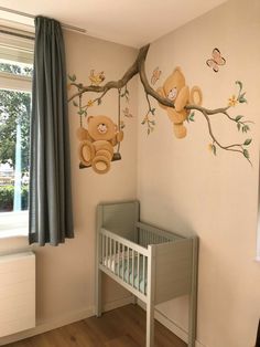 a baby's room with a teddy bear mural on the wall