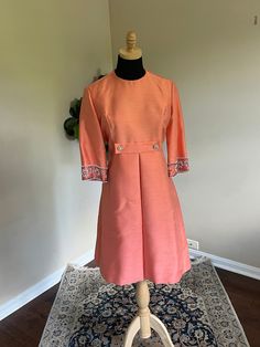 Gorgeous 1960s salmon-colored (pink/orange) cocktail dress with beautiful beading details by the fabulous Mardi Gras of New York. This midcentury beauty is in Excellent condition. Skirt is gathered in front Hook and eye closures at nape of neck and waist, as shown. In the 1960s, Levino Verna, a costume designer of Broadway productions, designed for Mardi Gras. A classic piece for a vintage lover and collector of midmod clothing. Perfect dress for a mother of the bride or mother of the groom look Mother Of The Groom Looks, Orange Formal Dresses, Orange Cocktail Dresses, Bride Dress Vintage, Orange Cocktail, Dress Mother Of The Bride, Designer Cocktail Dress, Dress Unique, Costume Designer