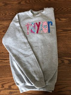 This sweatshirt is even better in person! So CUTE! Perfect for a birthday gift or just because. This listing is for YOUTH sizes. Name will be appliqued front center of sweatshirt I use Gildan Brand Crew Neck (Youth Sizes S - XL). S = 6-8, M = 10-12, L = 14-16, XL = 18-20 NOTE: These are YOUTH sizes! I have tons of color options. The best way would be to order a sweatshirt, let me know what fabric colors you want for the name and I will send you options. This is a custom made sweatshirt and there Cotton Sweatshirt For Birthday In Winter, Cotton Sweatshirt For Winter Birthday, Personalized Cotton Sweatshirt For Winter, School Crew Neck Sweatshirt With Name Print, Cute Cotton Crew Sweatshirt, Cute Cotton Crew Neck Sweatshirt, Casual Cotton Sweatshirt For Birthday, Personalized Cotton Crew Neck Sweatshirt, Fun Cotton Crew Neck Sweatshirt