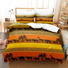 a bed with an orange, yellow and black comforter set on top of it