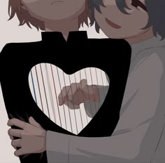 two people are hugging each other with their arms around one another and holding a heart shaped object