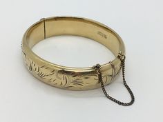 A sterling silver gold plated hinged bangle with engraved detailing to one side (plain to the other - hallmarked for Sheffield 1982 (also marked sterling silver). Stamped gold plated to clasp. Some light wear to the gold plating, but otherwise in good vintage condition with light surface marks Measures 70 x 60 x 15mm tall and weighs a good 23.2g My items are all used, vintage or antique and so will have signs of usage and wear from a past life. As always, please view the images to help judge con Hinged Bangle, Past Life, Silver And Gold, Sheffield, Gold Plating, Vintage Sterling Silver, Bangle Bracelets, Silver Gold, Jewelry Bracelets