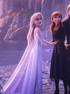 the frozen queen and prince are standing next to each other