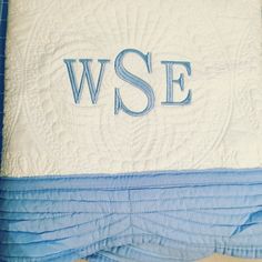 a blue and white quilt with the word wse on it