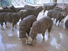 several sheep made out of wires on the floor