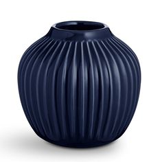 a large blue vase sitting on top of a white table