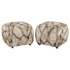 a pair of stools made out of wood with black and white designs on them