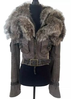 a mannequin wearing a jacket with fur collars and belted cuffs on it