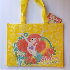 a yellow shopping bag with ariel the little mermaid on it