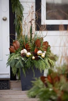 a planter filled with greenery and christmas decorations