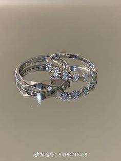 three silver rings with diamonds on them are shown in an image that appears to be made out of metal