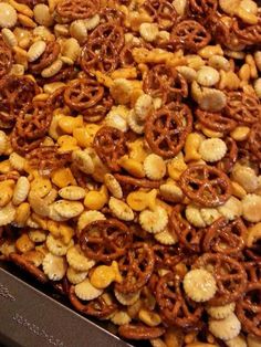 there are many pretzels and nuts in the tray