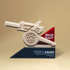 a wooden toy airplane on top of a blue and red award plaque that says red - leg community award