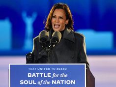 a woman standing at a podium in front of microphones and a sign that says battle for the soul of the nation