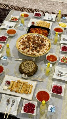 a table filled with lots of food and condiments on top of it,