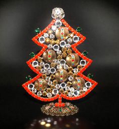 a beaded christmas tree on a black background