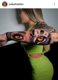 a woman's arm with an orange eye and tiger tattoo on the upper half of her arm