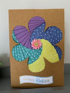 a birthday card with colorful umbrellas and flowers on the front that says happy birthday