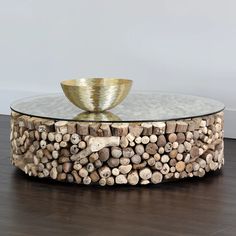 a glass table topped with logs and a bowl