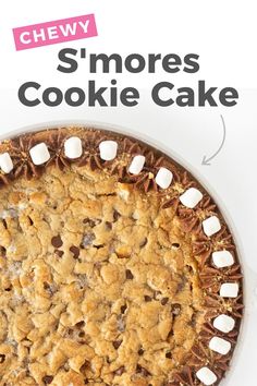 a cookie cake with marshmallows on top and the words chew s'mores cookie cake above it