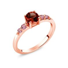 a rose gold ring with an orange and pink diamond