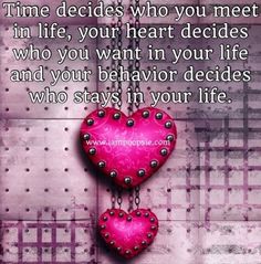 two hearts hanging from a chain with the words time decides who you meet in life, your