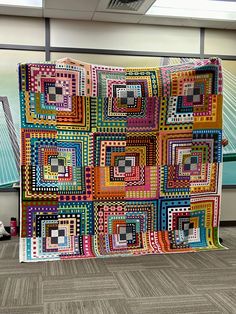 a multicolored quilt on display in an office