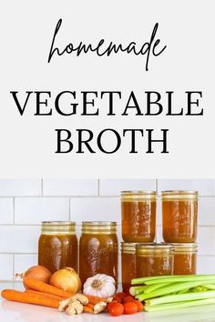 homemade vegetable broth in jars with carrots and celery on the counter