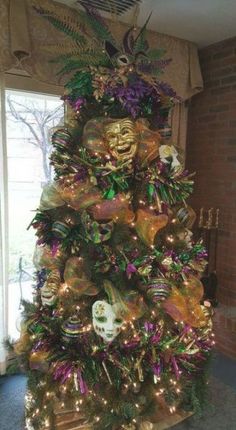 a christmas tree decorated with masks and lights