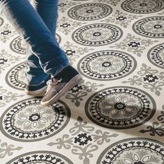 a person standing on top of a patterned floor