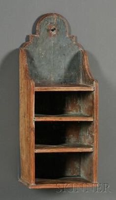 an old wooden shelf with two open shelves