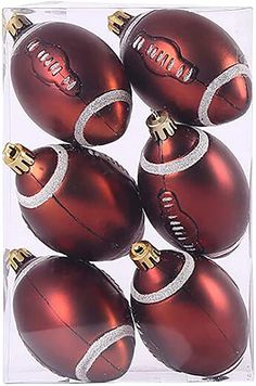 six shiny red christmas balls in a clear box with gold trimmings on each ornament