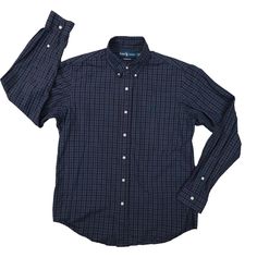 Elevate your wardrobe with this vintage Ralph Lauren plaid shirt in navy blue. This button-up shirt features a collared neckline and long sleeves, making it suitable for any occasion, be it travel, weddings, or workwear. The shirt is made of woven cotton fabric, which is easy to care for and perfect for all seasons. It comes with a regular fit and is available in size medium. The shirt is adorned with an embroidered logo and button accents, giving it a classic business casual look. This shirt is a must-have for any fashion-conscious man who wants to add a touch of sophistication to his wardrobe. Classic Business Casual, Conscious Man, Ralph Lauren Vintage, Mens Navy, Woven Cotton, Blue Plaid, Button Up Shirt, Plaid Shirt, Custom Fit