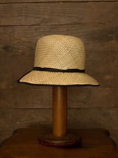 "An authentic antique woven cloche from the late 1920s or 30s era. Originally acquired by a European hat shop that closed in the 1930s. Made from a light colored woven straw with a simple yet elegant black wax coated ribbon and buckle. Only minor signs of age from storage, never been previously used. Centimeter measurements written on the inside of the crown by the hat maker. material : straw, silk? ribbon color : black, light beige condition : little to no wear, has never been used size : pleas Classic Cloche Hat For The Beach, Vintage Cloche Hat With Short Brim For Beach, Retro Adjustable Straw Hat With Short Brim, Vintage Cloche Hat With Flat Brim For Summer, Vintage Fedora Sun Hat For Kentucky Derby, Vintage Short Brim Panama Hat For Kentucky Derby, Vintage Panama Hat For Kentucky Derby With Short Brim, Adjustable Natural Cloche Hat With Short Brim, Vintage Wide Brim Panama Hat With Adjustable Fit