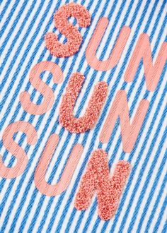 an image of the word sunburn on a striped blue and white shirt with pink sequins